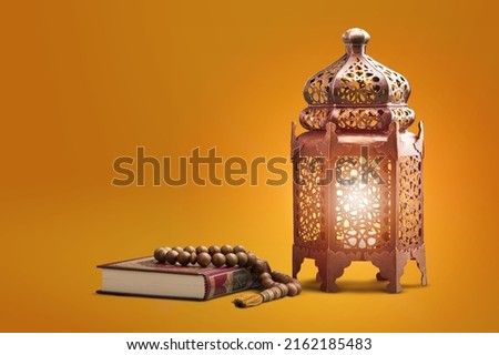 Fawanis. Traditional Ramadan lantern with prayer beads on background. Royalty-Free Stock Photo #2162185483