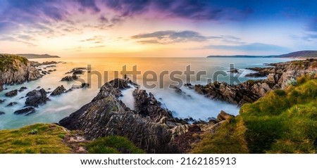 Dawn over the sea horizon and coastal cliff beach. Sea cliff on coastal beach Royalty-Free Stock Photo #2162185913
