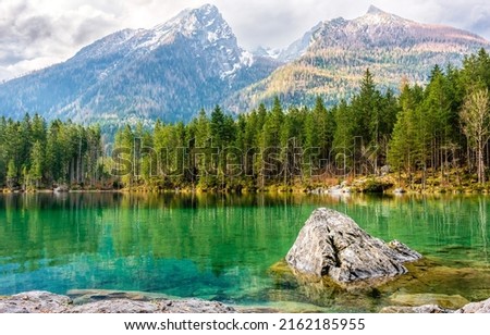 Green water of a mountain lake. Mountain lake landscape. Beautiful lake in mountains. Mountain forest lake landscape Royalty-Free Stock Photo #2162185955