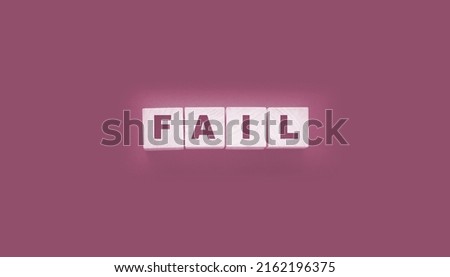 FAIL Word text Written In Wooden Cube blocks on black background. Business crisis concept.