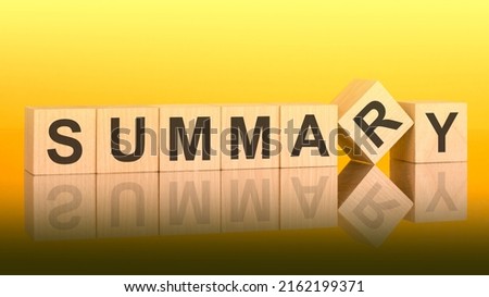 SUMMARY word written on wood block. yellow background. business concept. inscription on the cubes is reflected from the surface of the table. a color gradient is used