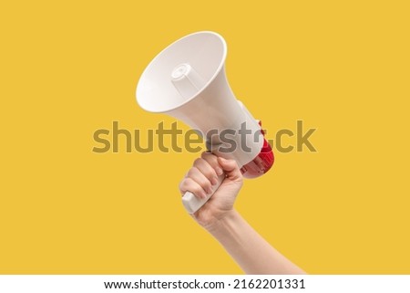 Megaphone in woman hands on a white background.  Copy space.  Royalty-Free Stock Photo #2162201331