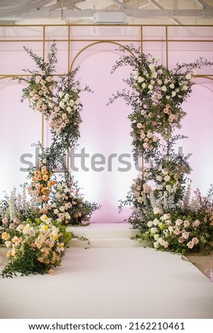 Arch for an outdoor wedding ceremony in the hall. Royalty-Free Stock Photo #2162210461