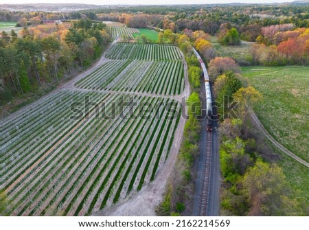 aerial view of train near farmland in spring Royalty-Free Stock Photo #2162214569