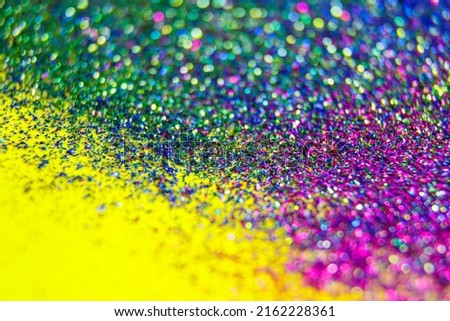 Abstract colourful purple creative macro bokeh background. Multi colored glitter becoming defocused, shining bokeh