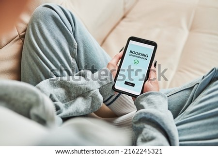 Woman booking vacation online. Person paying for hotel from home. Booking flight using mobile payment app. Purchasing service using smartphone. Online shopping from home. Order confirmation on screen Royalty-Free Stock Photo #2162245321