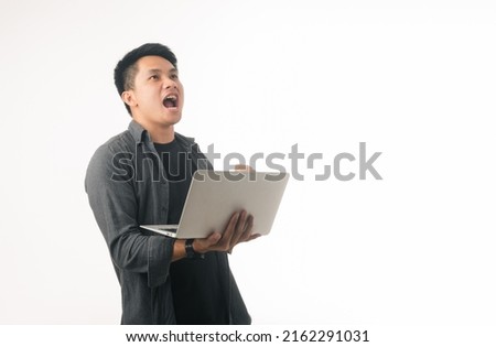 Young asian gesturing YES in front of laptop, celebrating success at home office. making great deal, signing online contract, excited over achievement on white background