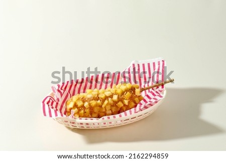 Delicious Crunchy Korean Style Chunky Potato Corn Dogs with Batter and Fried Potatoes. Isolated on Cream Background with Copy Space for Text Royalty-Free Stock Photo #2162294859