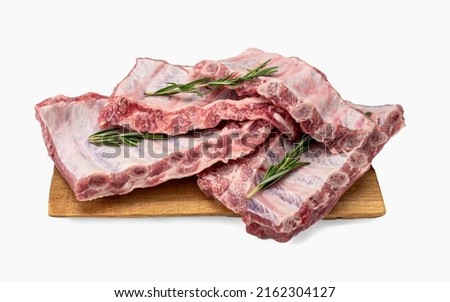Raw pork ribs. Whole raw pork ribs on wooden board isolated background. Raw meat, farm and cooking concept. Meat shop. Racks of fresh raw pork meat ribs isolated on white background Royalty-Free Stock Photo #2162304127