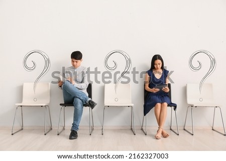 Young Asian people waiting for job interview indoors