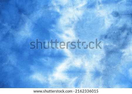 Abstract tie dye indigo blue fabric cloth Boho pattern texture for background or groovy wedding card, sale flyer, 60s, 70s poster, kid tie-dye diy backdrop. Modern Watercolor Wet Brush Fabrics Art Royalty-Free Stock Photo #2162336015
