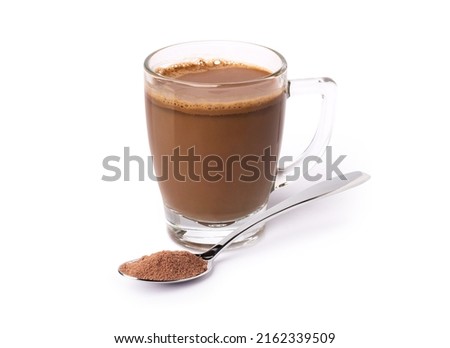 Glass mug of hot chocolate drink with cocoa powder in stainless steel teaspoon isolated on white background.