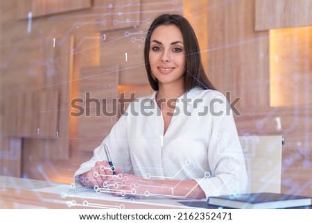 Portrait of attractive businesswoman in formal wear working with documents and thinking how to optimize business process by applying new technologies. Hi tech holograms over modern office background