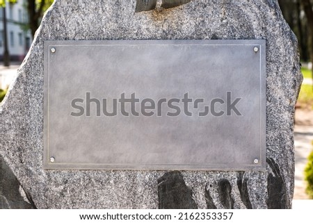 part of a granite  monument with an empty tablet Royalty-Free Stock Photo #2162353357