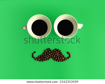 Creative layout made of coffee cups and coffee beans mustache against gradient green background. Flat lay, copy space. Coffee art. Minimal design. Gentleman's club. Man's coffee. 