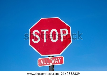 Stop sign under blue sky in USA with all way addition, USA