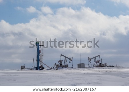 Oil production in Tatarstan. Winter landscape with an oil rocking chair. Oil pump with chain drive. 2 types of oil rockers.