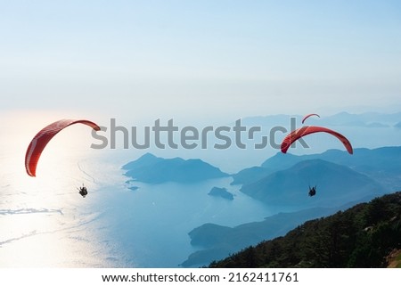 Paraglider flying on Oludeniz beach in Fethiye, Mugla. Travel destination. Summer and holiday concept. Royalty-Free Stock Photo #2162411761