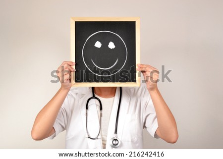 Doctor with smiling face in blackboard