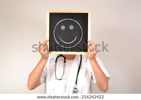 Doctor with smiling face in blackboard