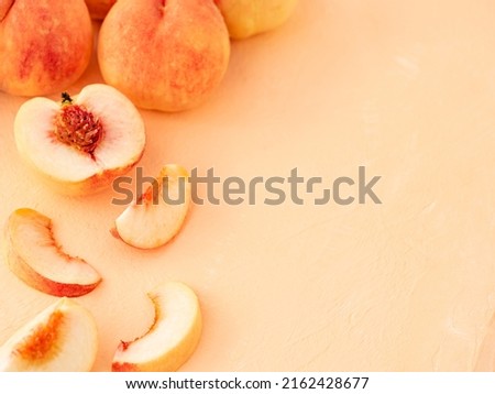 Summer fruit background. Composition with pale pink tender peaches. Ripe fresh organic fruit, vegan food. Harvest concept. Fruity summer diet concept. Copy space for text. Royalty-Free Stock Photo #2162428677