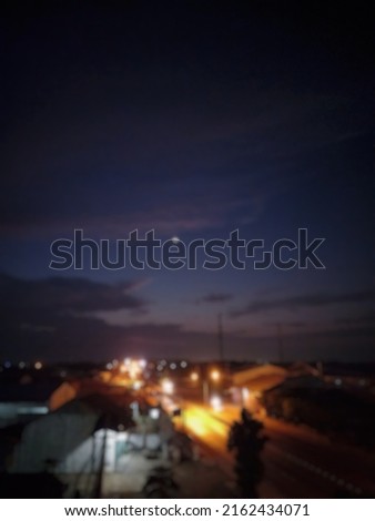 Defocus abstract background of a beautiful view at night with sparkling lights on the side of the road and under the moonlight