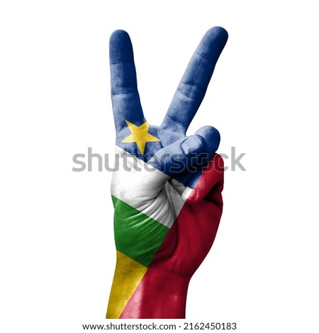 Hand making the V victory sign with flag of central african republic