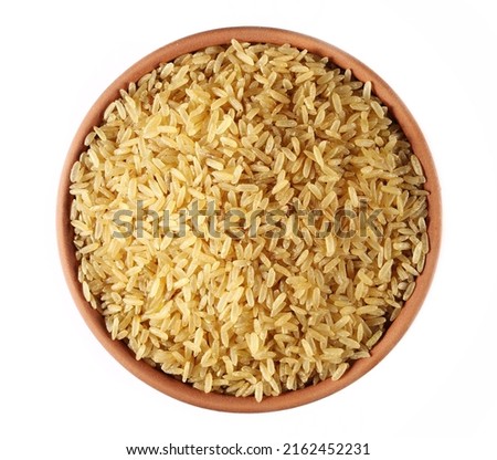Integral uncooked rice pile in clay pot isolated on white, top view   Royalty-Free Stock Photo #2162452231