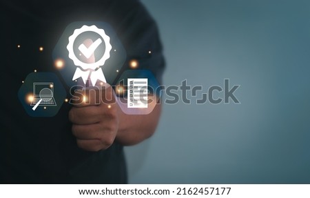 Businessman thumbs up to show signs, quality assurance, warranty, product and service standards, ISO certificates, surveys, customer databases. Concept of standardizing products and services Royalty-Free Stock Photo #2162457177