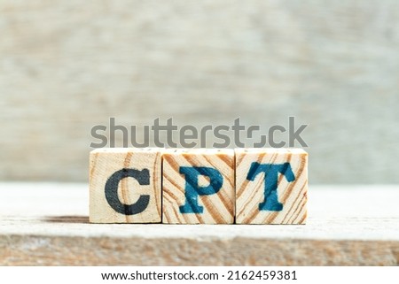 Alphabet letter block in word CPT (Abbreviation of Carriage Paid To) on wood background