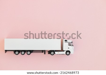 Modern white truck on pink background . Space for text. Delivery and logistics concept