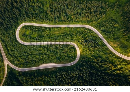 Bird's eye view from a drone flying over a winding road. Location place of Carpathians mountain, Ukraine, Europe. World landmarks. Photo wallpaper. Drone photography. Discover the beauty of earth. Royalty-Free Stock Photo #2162480631