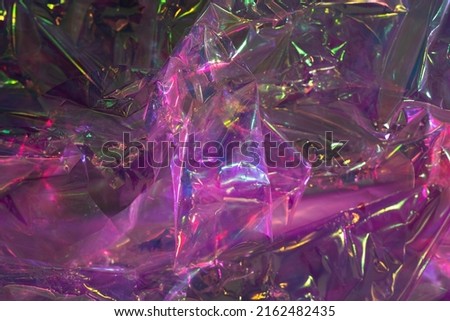 Crumpled cellophane. Closeup texture of bright violet pink plastic garbage bag. Purple polyethylene film background.  Royalty-Free Stock Photo #2162482435