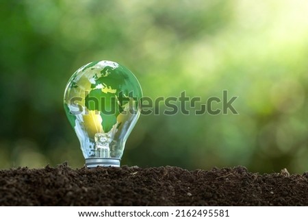 Renewable Energy.Environmental protection, renewable, sustainable energy sources. The green world map is on a light bulb that represents green energy Renewable energy that is important to the world Royalty-Free Stock Photo #2162495581