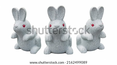 Red eyed rabbit stone statue isolated.