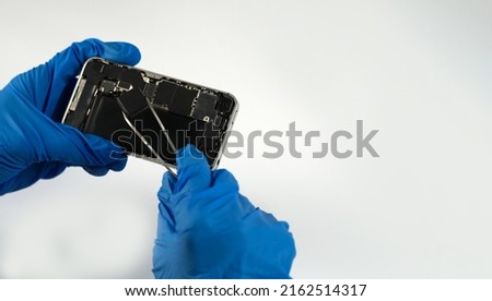 Technician repairing the Cell phone parts and tools for recovery repair phone smartphone and upgrade mobile technology,the concept of computer hardware inside.	
