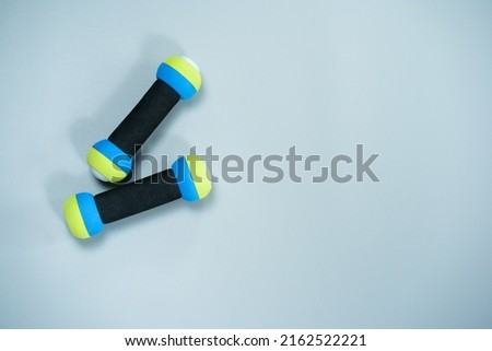 top view workout equipment with dumbbell on gray background