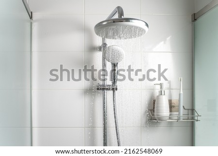 Jets of clean water flowing in the shower cabin. Selective focus. Royalty-Free Stock Photo #2162548069