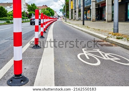 Separated bike lane on a main street in Berlin to improve road safety at the expense of parking lane.