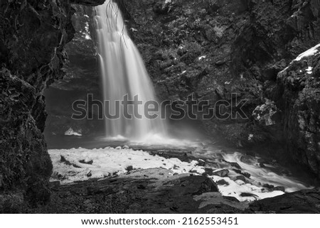 beautiful waterfall in the mountains, long exposure photo of water fall at winter concept idea low angle photo.