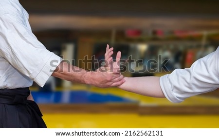 Aikidoka uses the technique joint lockon the opponent during the training of aikido Royalty-Free Stock Photo #2162562131