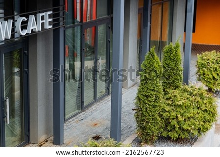 Vegetarian cafe, sign hanging on the street, cafe for yogis, fresh food, restaurant of oriental cuisine, facade of the building. High quality photo