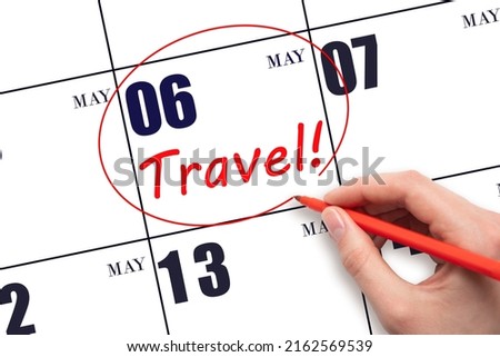 6th day of May. Hand drawing a red circle and writing the text TRAVEL on the calendar date 6 May. Travel planning. Spring month. Day of the year concept.