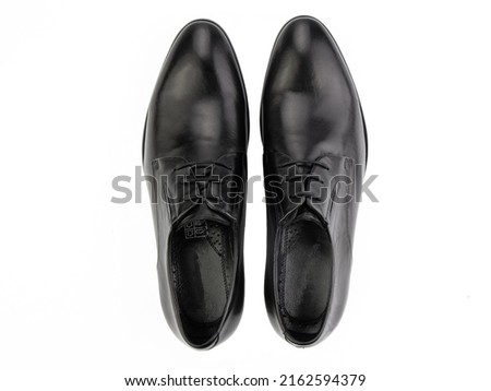 A pair of classic leather elegant men's shoes isolated white background. Groom's stylish black shoes. Isolated object close up on white background. Top view Royalty-Free Stock Photo #2162594379