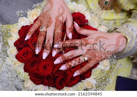 Henna Tattoo on Bride's Hand.Moroccan wedding preparation henna party. Temperate white mehndi. Modern mehendi art.

 Royalty-Free Stock Photo #2162594845