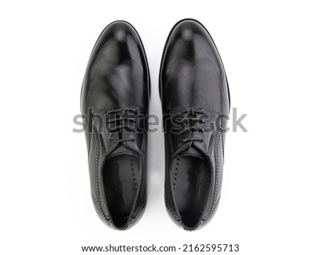 A pair of classic leather elegant men's shoes isolated white background. Groom's stylish black shoes. Isolated object close up on white background. Top view Royalty-Free Stock Photo #2162595713
