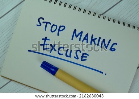Concept of Stop Making Excuse write on a book isolated on Wooden Table. Selective focus on Stop Making Excuse text