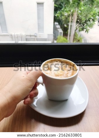 Picture of a hot coffee mug placed in a coffee shop, coffee time on a relaxing day