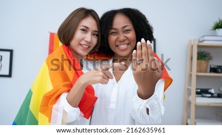 Diversity African American and Asian Married couples Lesbian LGBTQ. Married homosexual show Diamond ring.Sexual equality,LGBT Pride month,Parade celebrations concept.Family of happiness smiling. Royalty-Free Stock Photo #2162635961