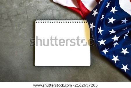 Independence Day. Day of USA. DAY OF VETERANS,DAY OF REMEMBRANCE. USA flag with white frame for text on a gray concrete background. Flat lay, copy space.
